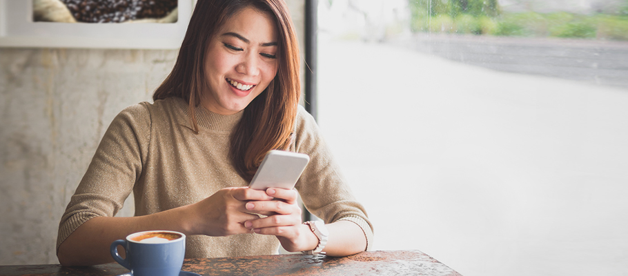 Smiling woman looking at her phone