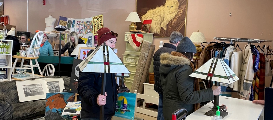 People standing in checkout line with Tiffany lamps