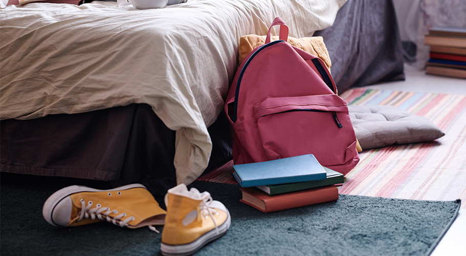 shoes and backpack sitting on kids' bedroom floor