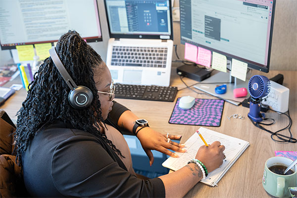 women on a call while taking notes