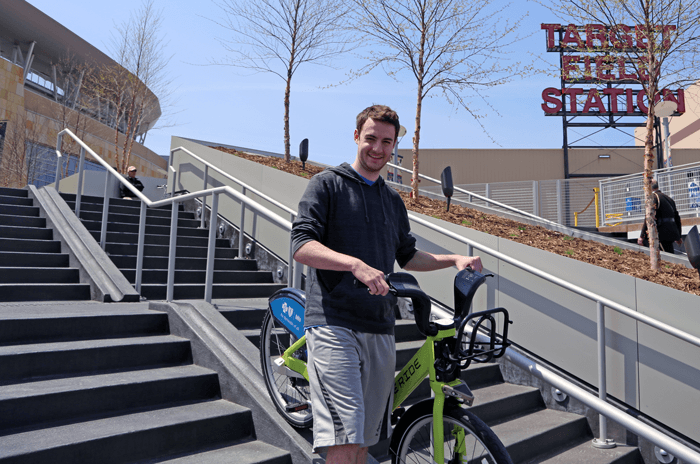 A photo of a visitor using the bike path feature in the middle of the staircase.